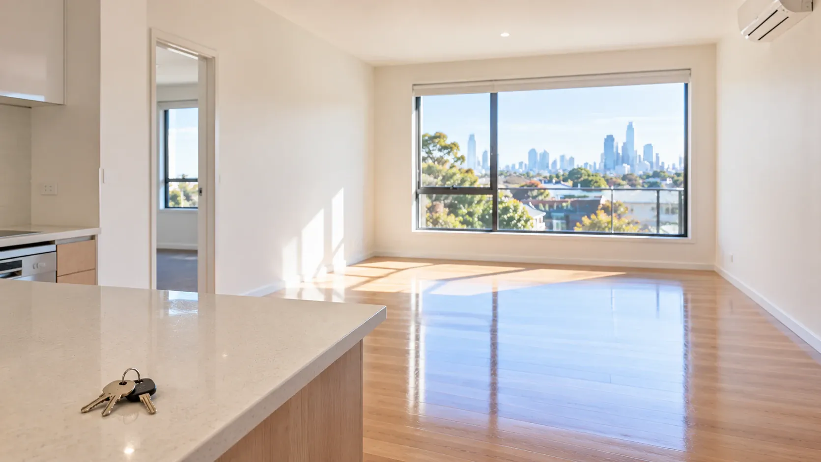 An empty, spotless apartment with the keys left on the bench